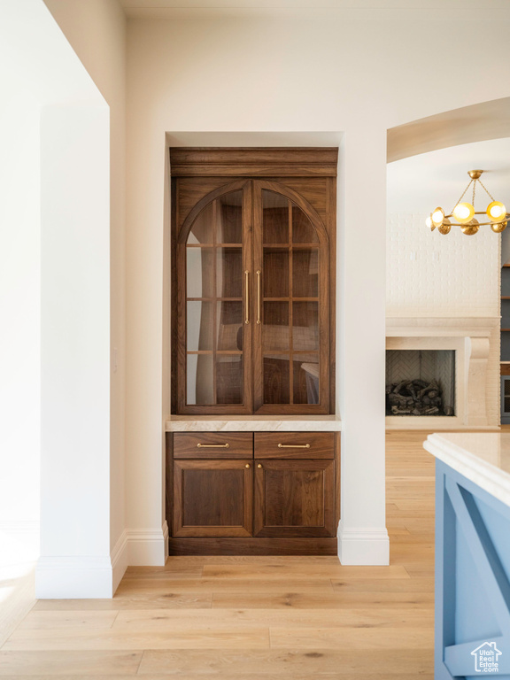 Room details with hardwood / wood-style floors and a notable chandelier