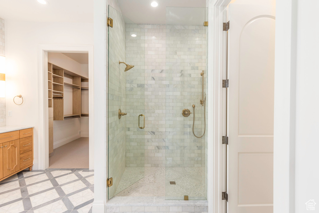 Bathroom with vanity and a shower with door