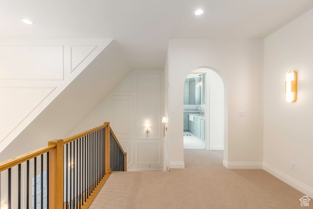 Bonus room featuring light colored carpet