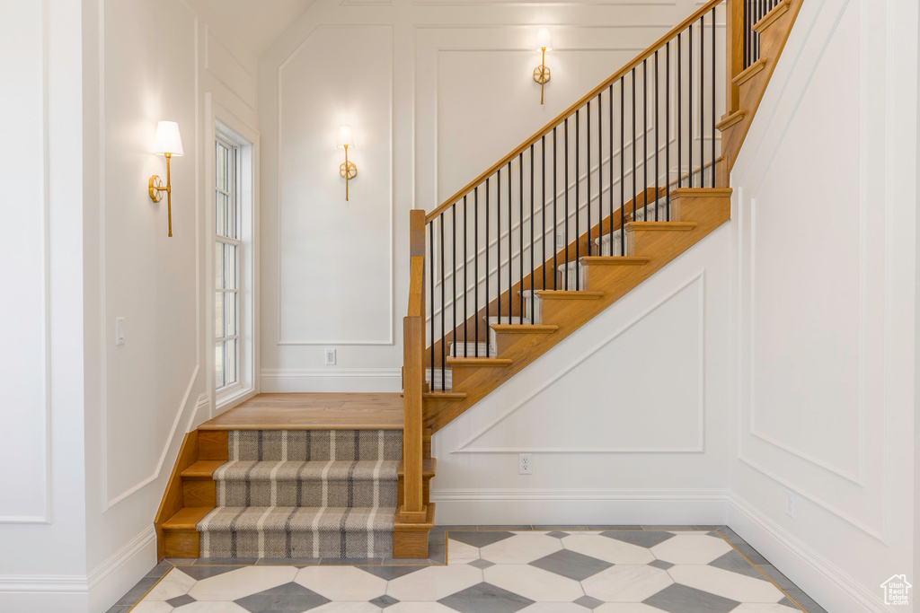 Stairs featuring wood-type flooring