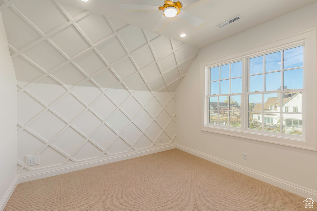 Additional living space featuring carpet and a healthy amount of sunlight