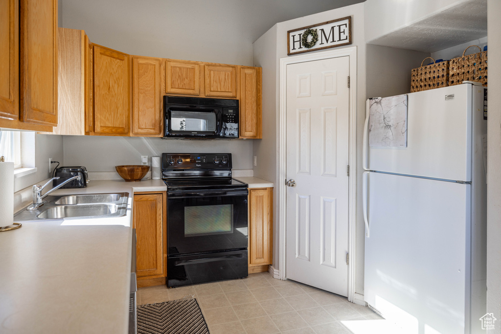 Kitchen featuring black appliances and sink