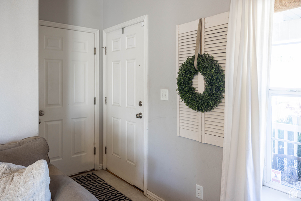 Doorway to outside featuring light tile patterned flooring