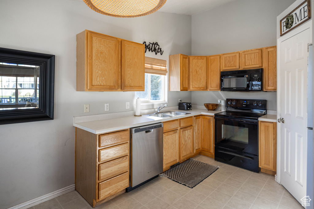 Kitchen with black appliances and sink