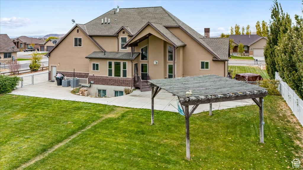 Rear view of house with a lawn