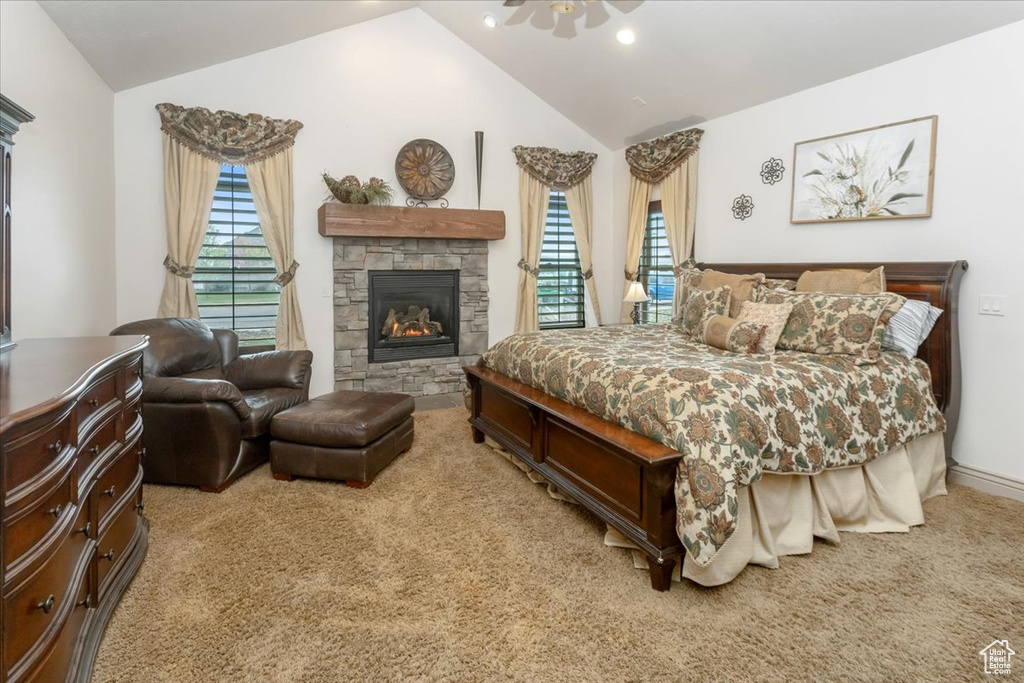 Carpeted bedroom featuring a fireplace and lofted ceiling