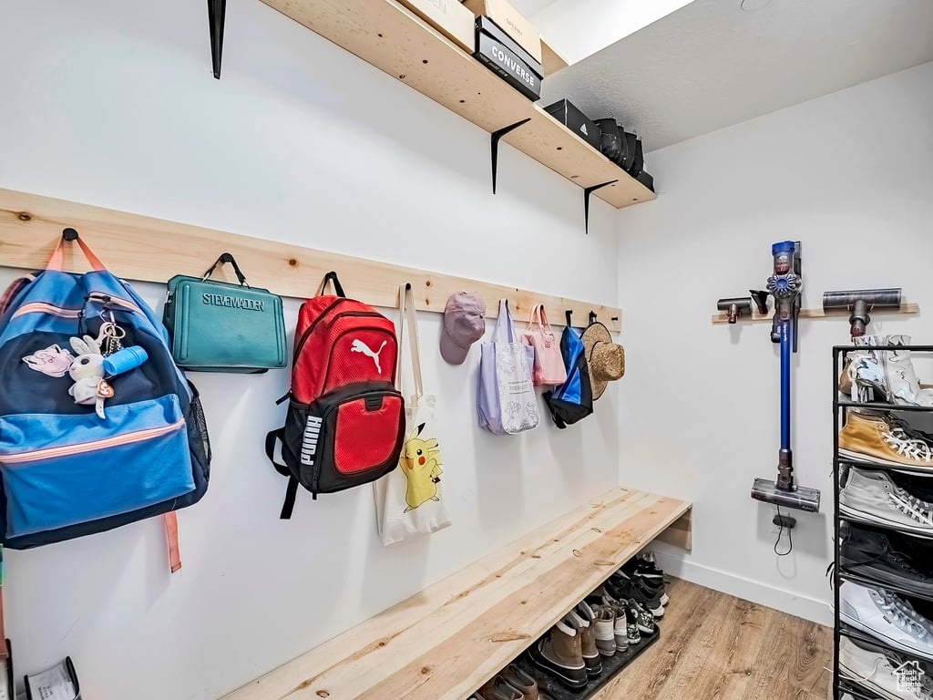 Mudroom featuring wood finished floors and baseboards