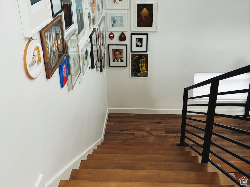 Stairway with baseboards and wood finished floors