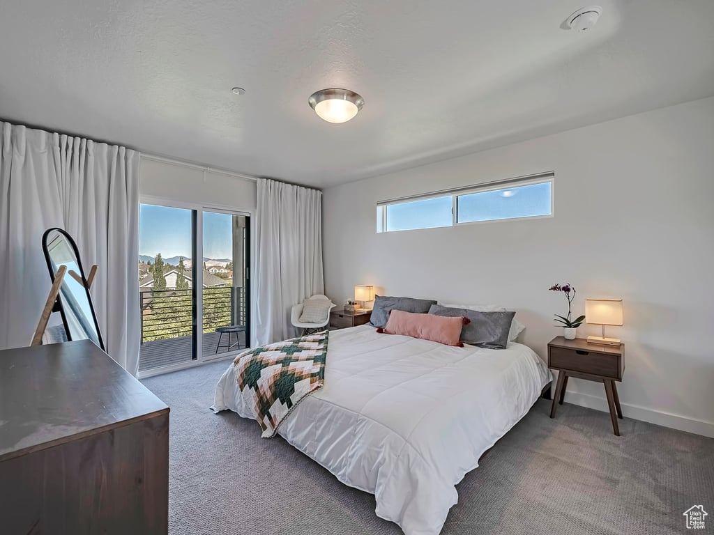 Bedroom with carpet flooring and access to outside