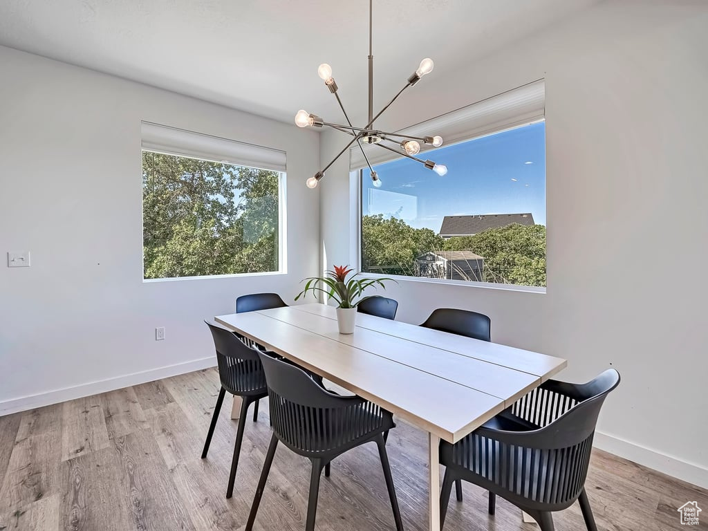 Dining space featuring a chandelier and wood finished floors