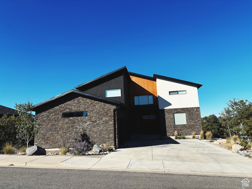 View of building exterior with concrete driveway