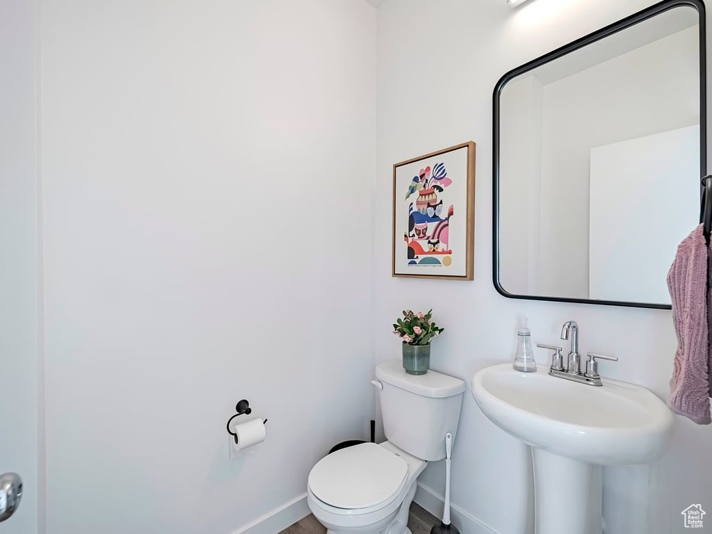Bathroom featuring toilet and baseboards
