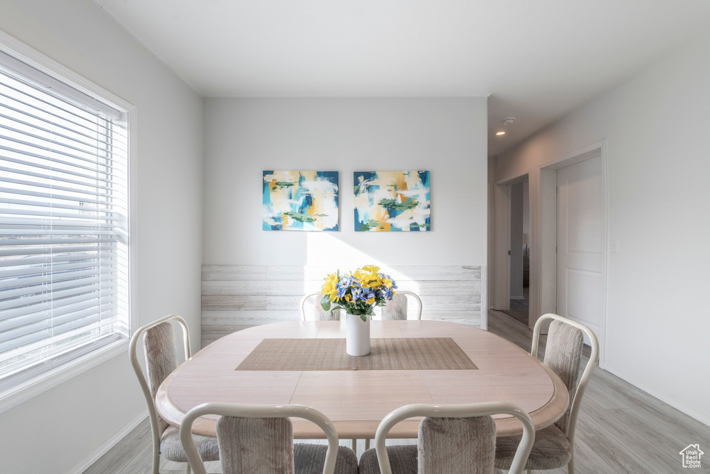 Dining space with light hardwood / wood-style flooring