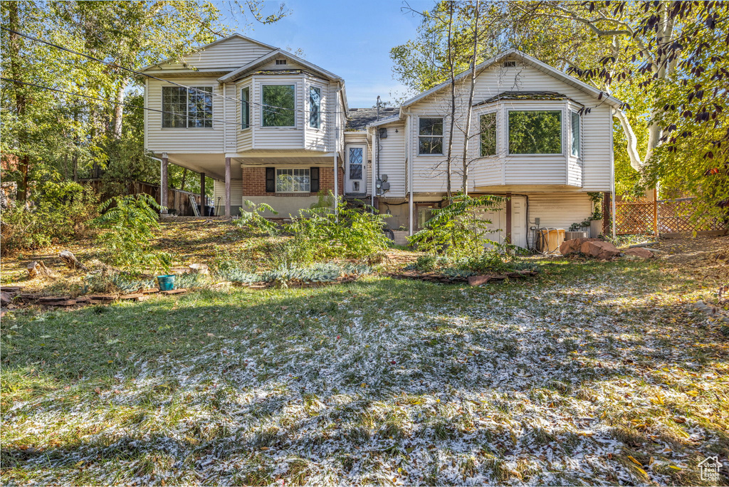 View of front of house with a garage and a front yard