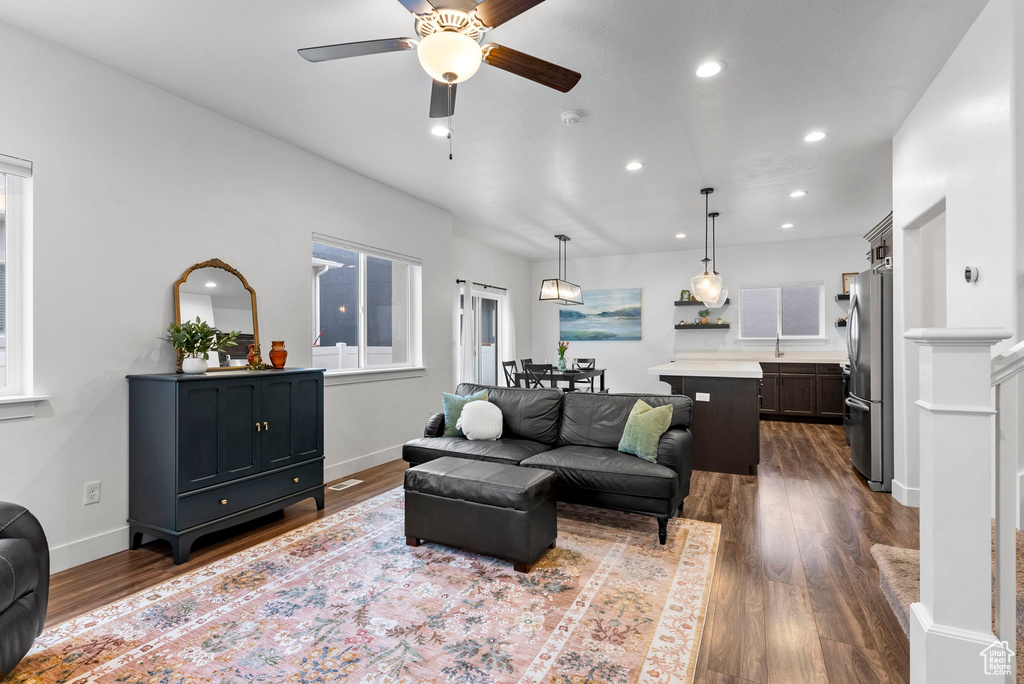 Living room featuring ceiling fan and dark hardwood / wood-style floors