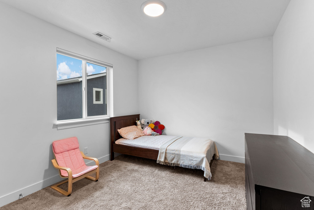 Bedroom with light colored carpet