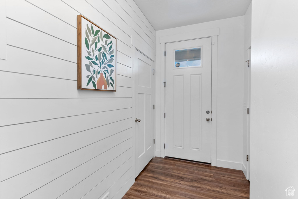 Doorway to outside featuring dark wood-type flooring