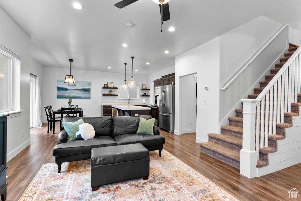 Living room with wood-type flooring and ceiling fan