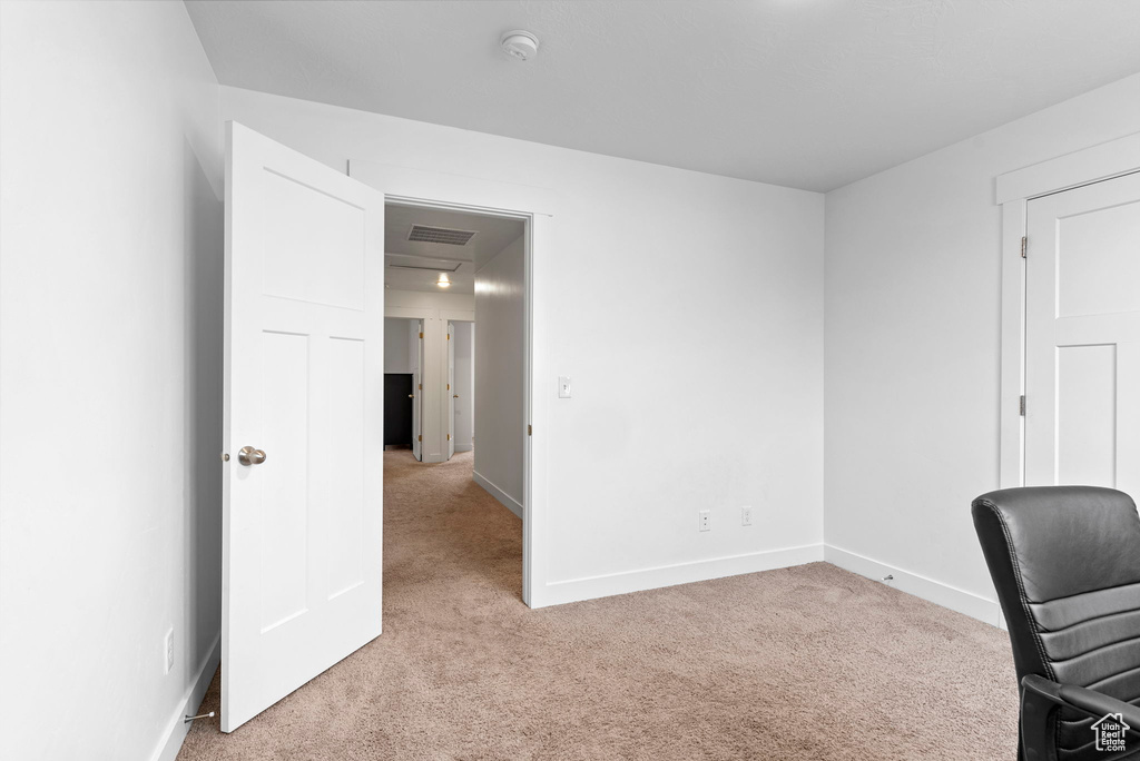 Unfurnished office with light colored carpet