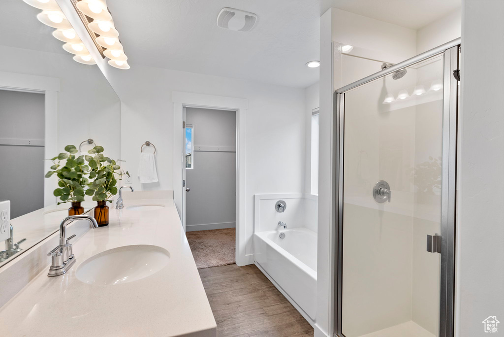 Bathroom with independent shower and bath, wood-type flooring, and vanity