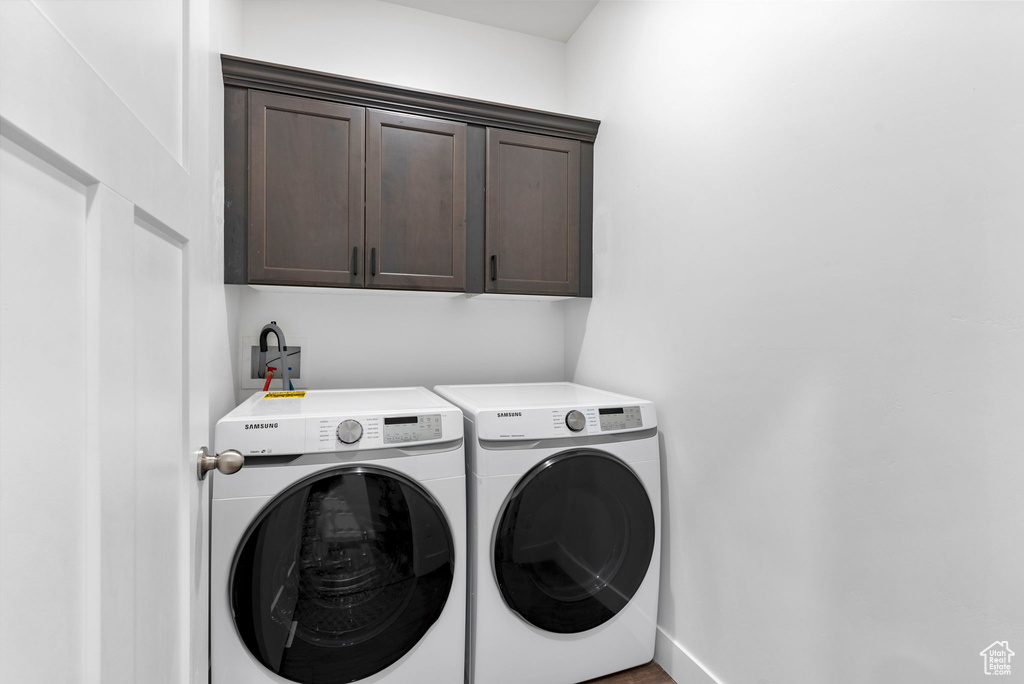 Laundry area featuring cabinets and separate washer and dryer