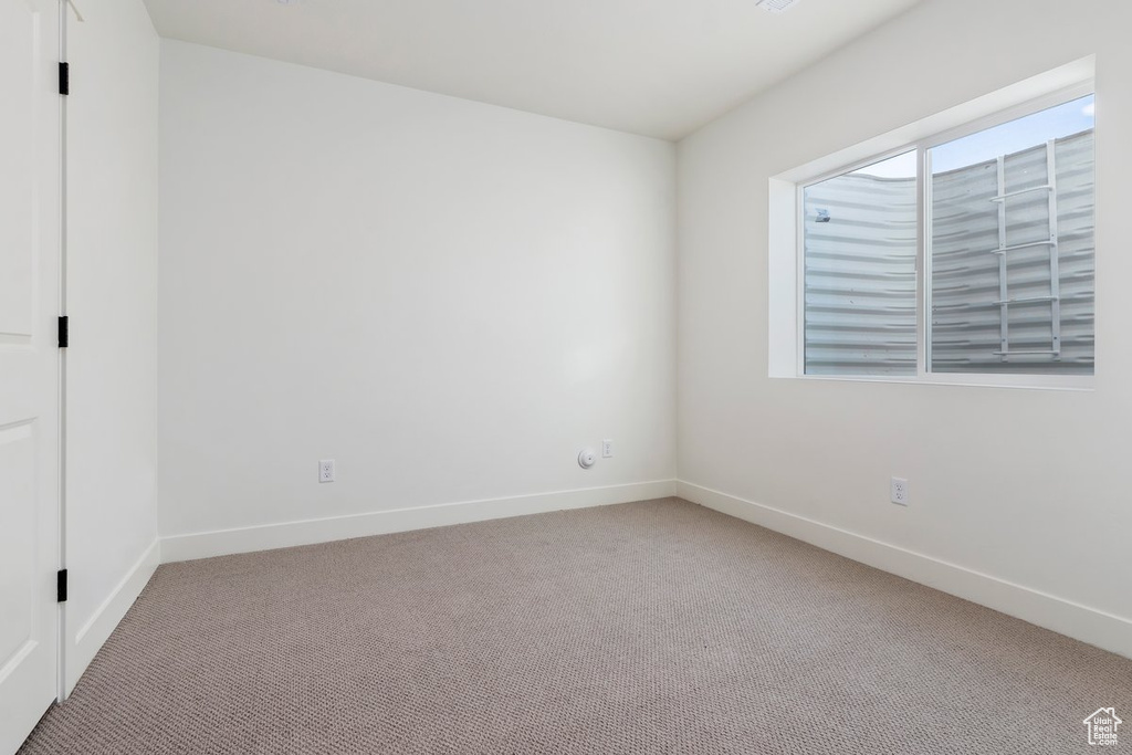 Spare room featuring light colored carpet