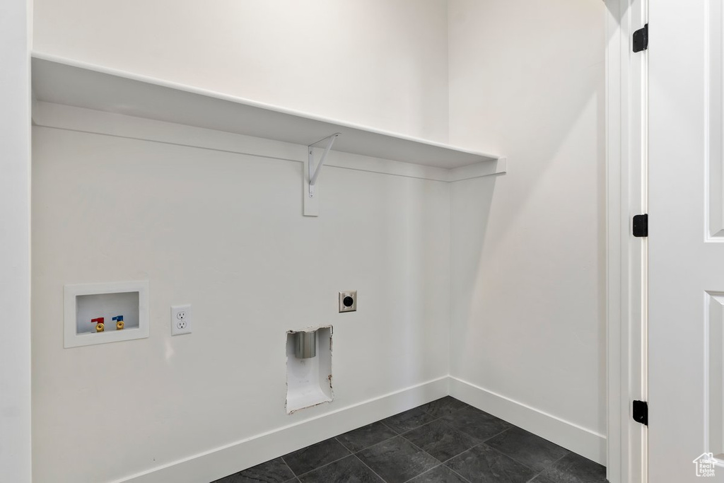 Laundry area with washer hookup, electric dryer hookup, and dark tile patterned flooring