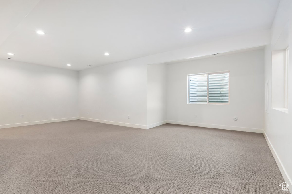 Unfurnished room featuring light carpet