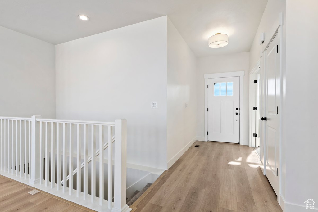 Foyer entrance with light hardwood / wood-style floors