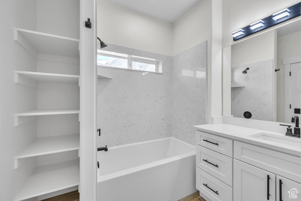 Full bathroom with a washtub and vanity