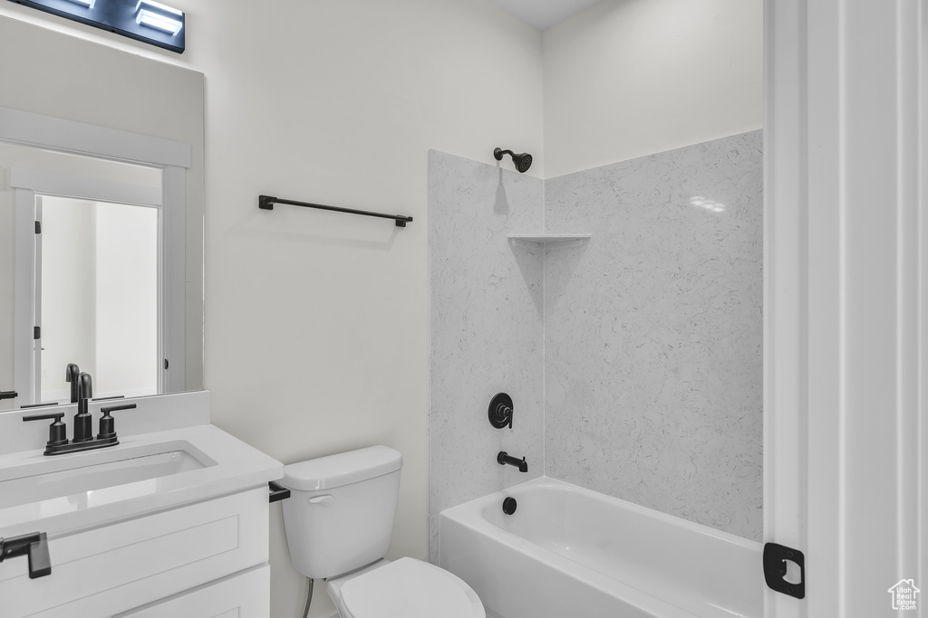 Full bath with toilet, vanity, and shower / bathing tub combination