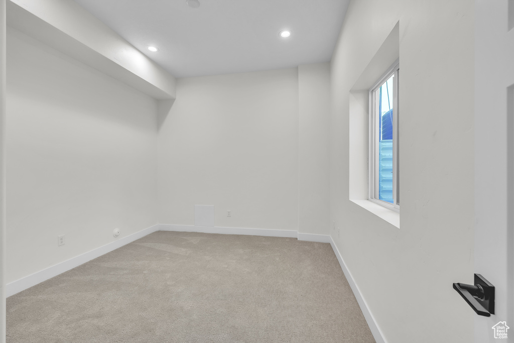 Unfurnished room featuring recessed lighting, baseboards, and light colored carpet