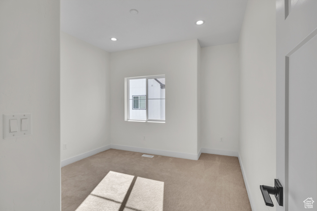 Unfurnished room with recessed lighting, baseboards, and light colored carpet