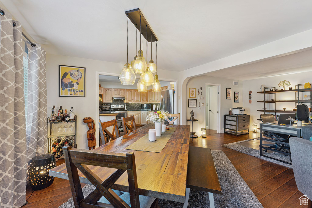 Dining space featuring dark wood-type flooring