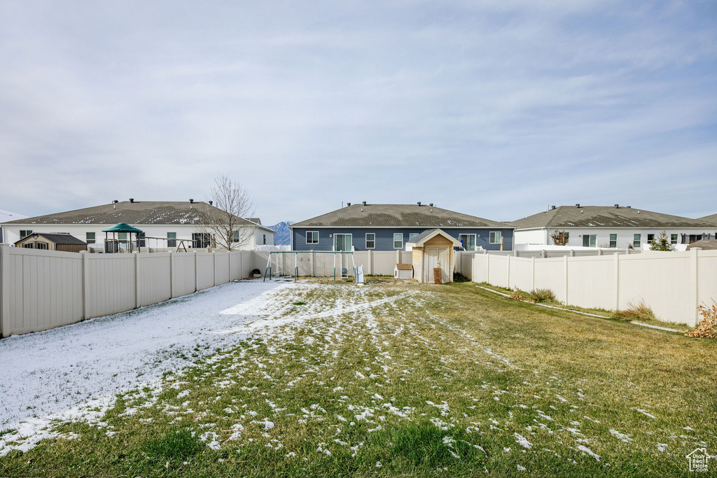 Back of house featuring a yard and a shed