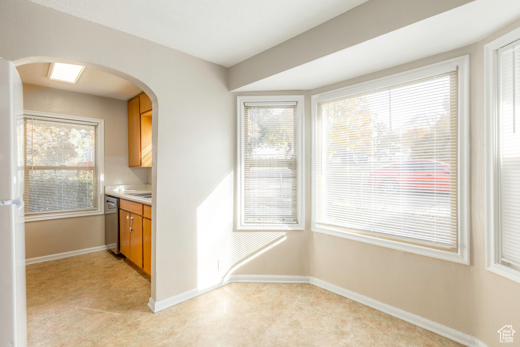 Kitchen featuring light carpet and stainless steel dishwasher