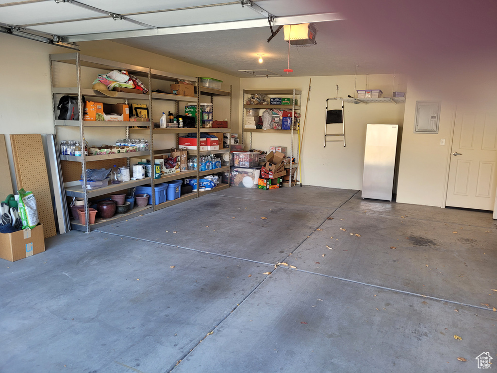 Garage with electric panel and a garage door opener