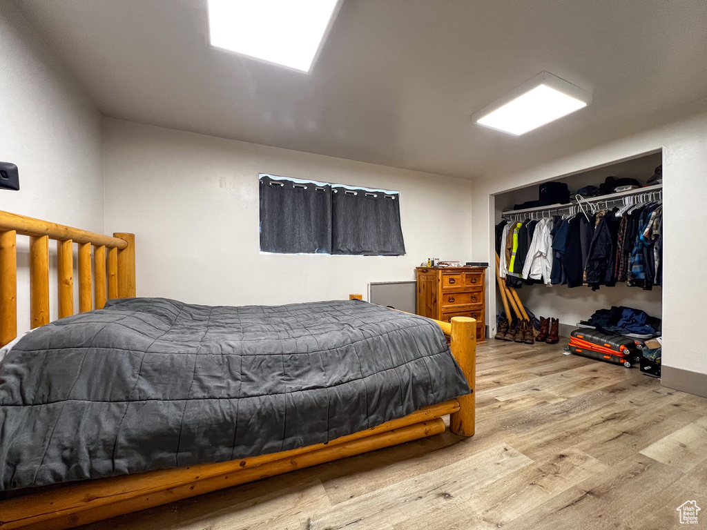 Bedroom featuring hardwood / wood-style floors and a closet