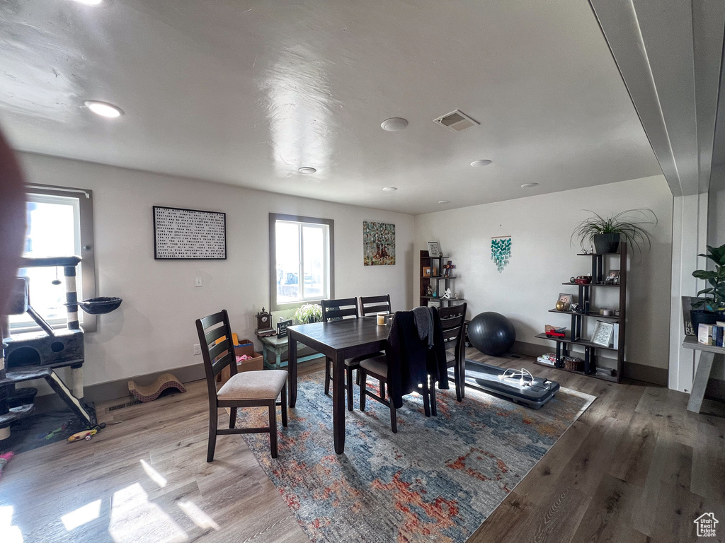 Dining area with hardwood / wood-style floors