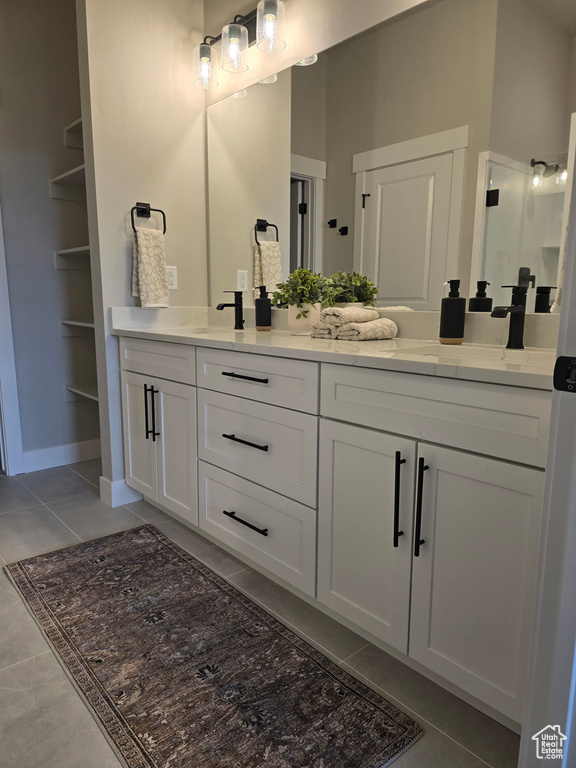 Bathroom featuring tile patterned floors, built in features, and vanity