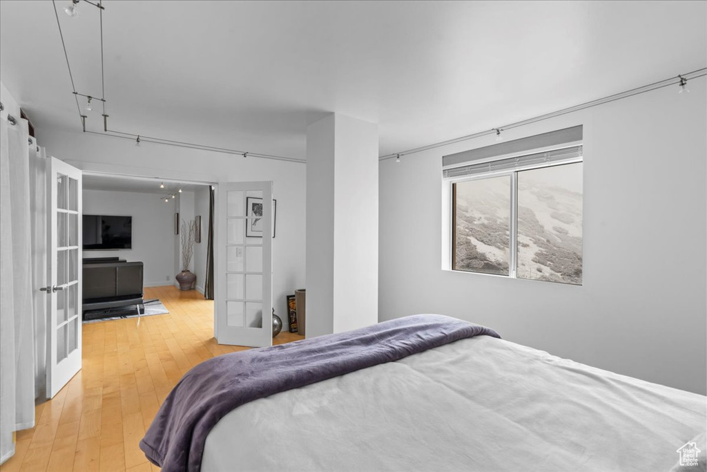 Bedroom featuring hardwood / wood-style flooring and french doors