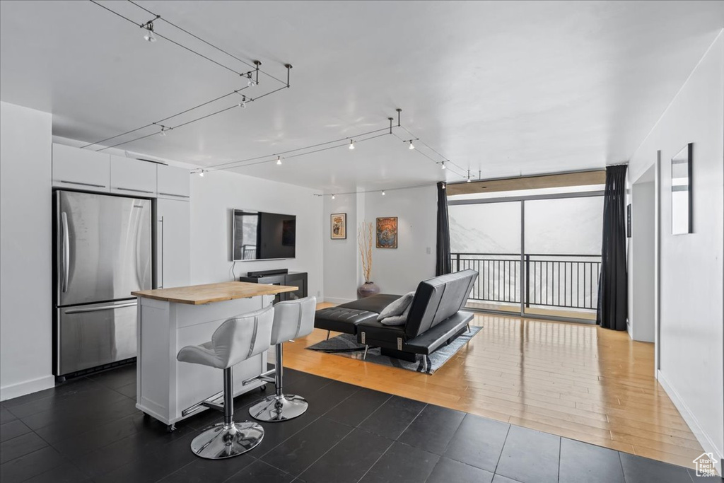 Living room with a wall of windows and dark hardwood / wood-style flooring