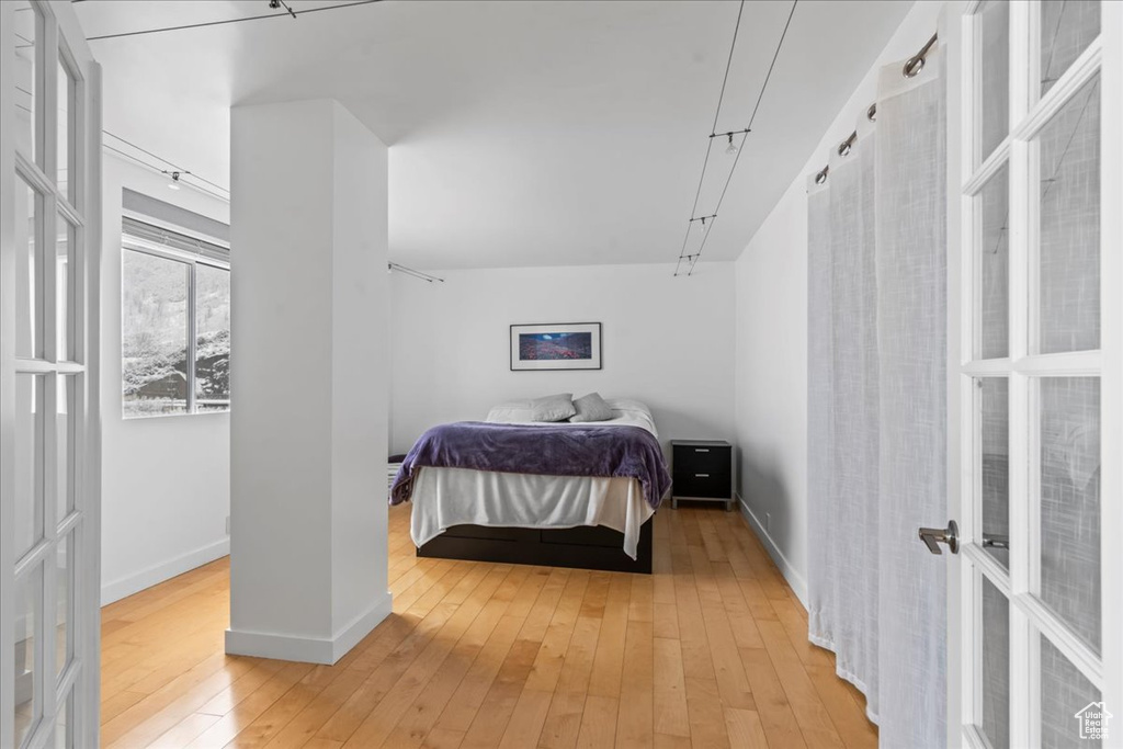 Bedroom with light hardwood / wood-style flooring