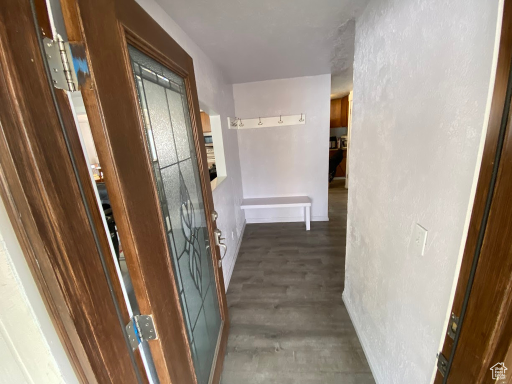 Corridor with dark hardwood / wood-style floors