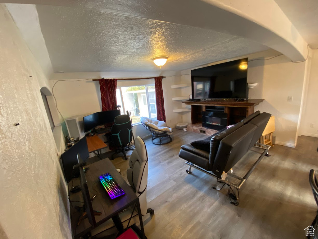 Living room with hardwood / wood-style floors and a textured ceiling