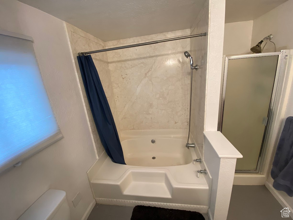 Bathroom featuring separate shower and tub and toilet