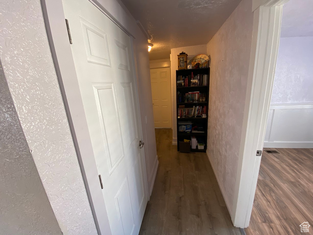 Hallway featuring dark hardwood / wood-style floors