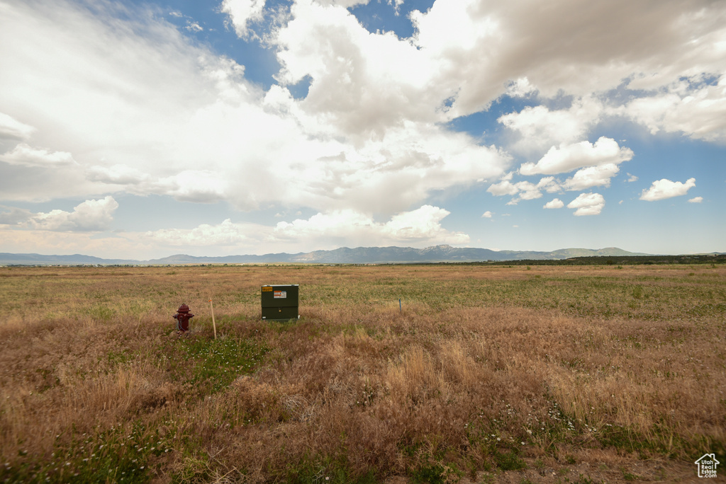 View of undeveloped land featuring a mountainous background and rural landscape