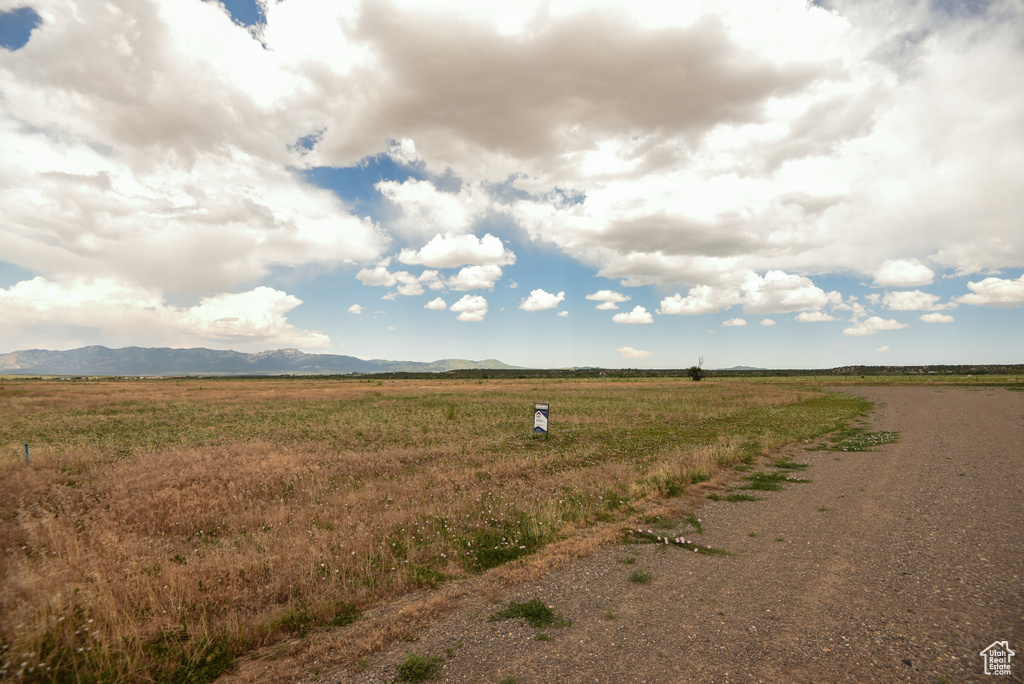 View of yard featuring a view of countryside and a mountain view