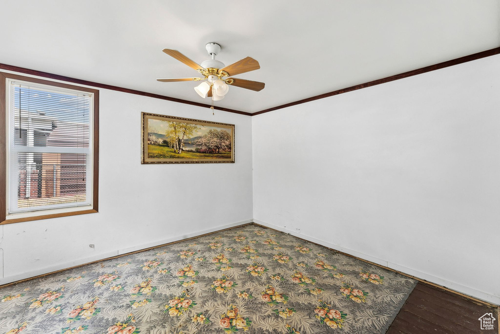 Unfurnished room featuring ornamental molding, ceiling fan, and hardwood / wood-style floors